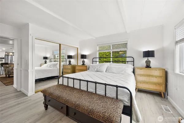 a bedroom with furniture and a wooden floor