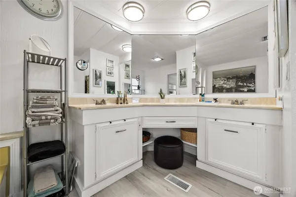 a spacious bathroom with a sink double vanity and a mirror