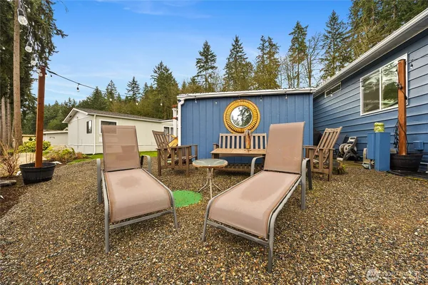 a view of a back yard with a couch and a fire pit