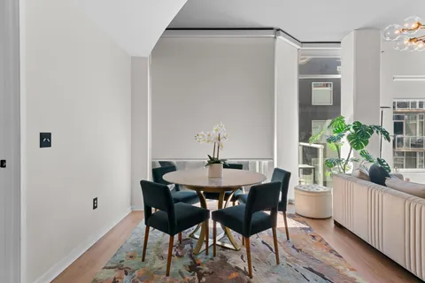 a dining room with furniture and wooden floor