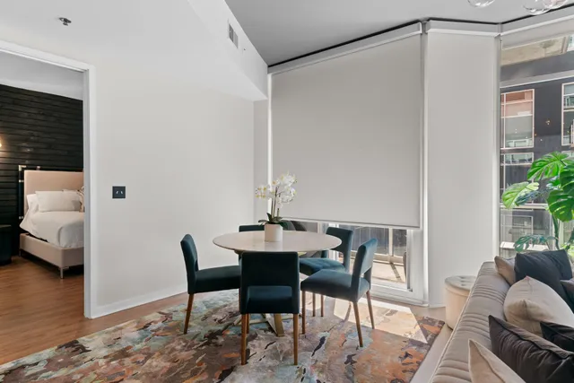 a view of a livingroom with furniture and a dining table