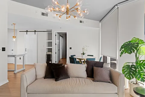 a living room with furniture and a chandelier