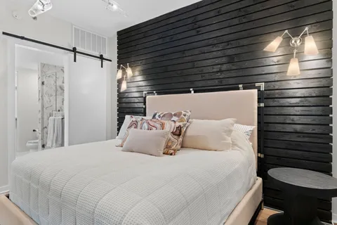 a bedroom with a bed and a window