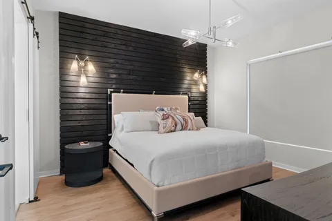 a bedroom with a bed and a night stand