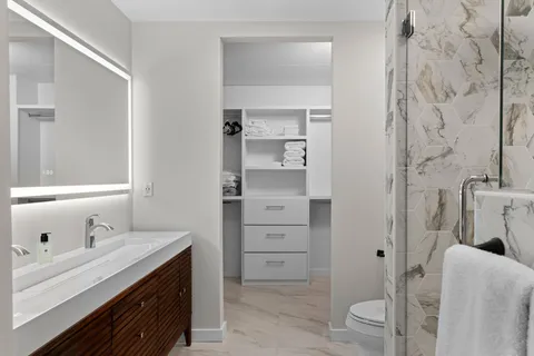 a bathroom with a sink toilet and shower