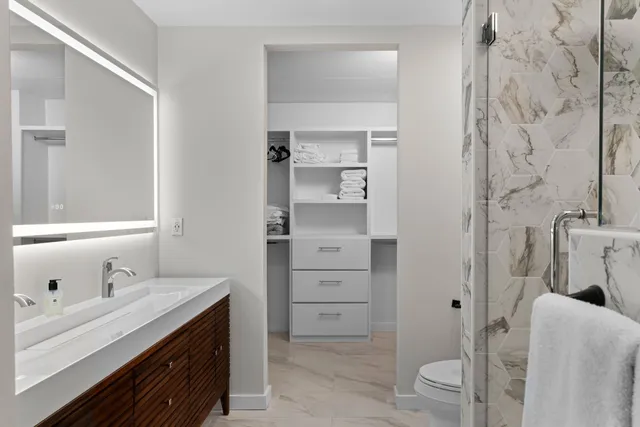 a bathroom with a sink toilet and shower