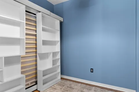 a view of walk in closet with empty racks