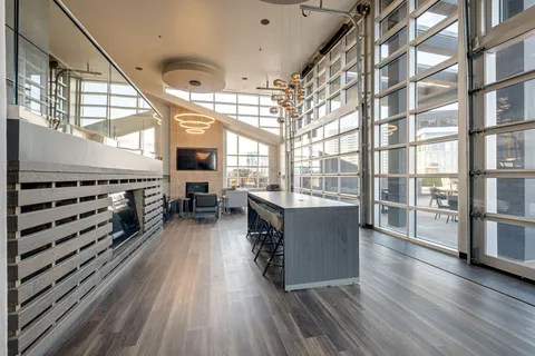 a view of a kitchen with furniture and wooden floor