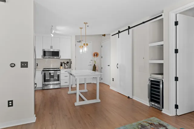 a kitchen with stainless steel appliances a refrigerator and a stove top oven