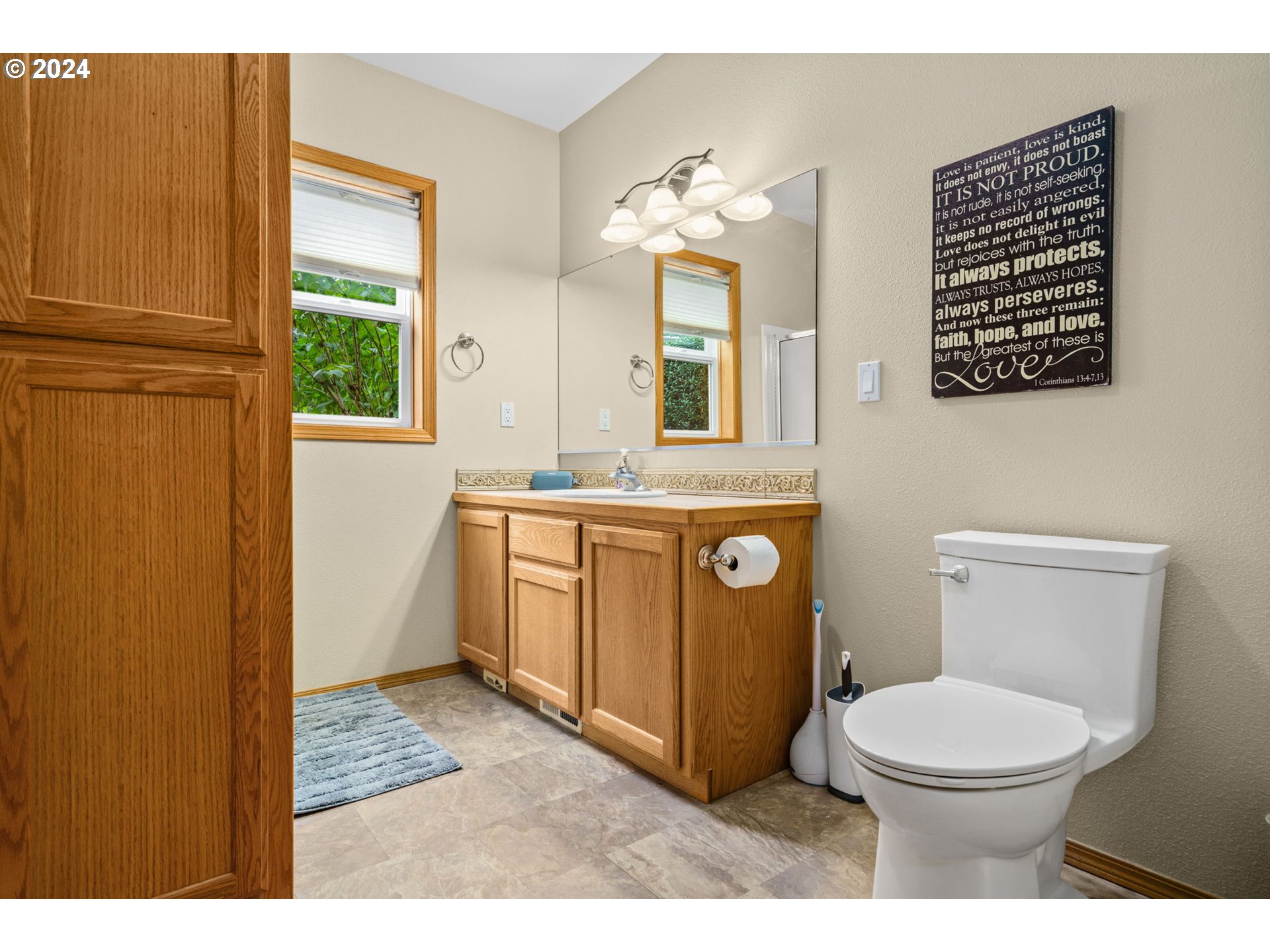 25241 Hall Road Cheshire, OR 97419 - Photo 14 of 48 a bathroom with a toilet a sink and a window