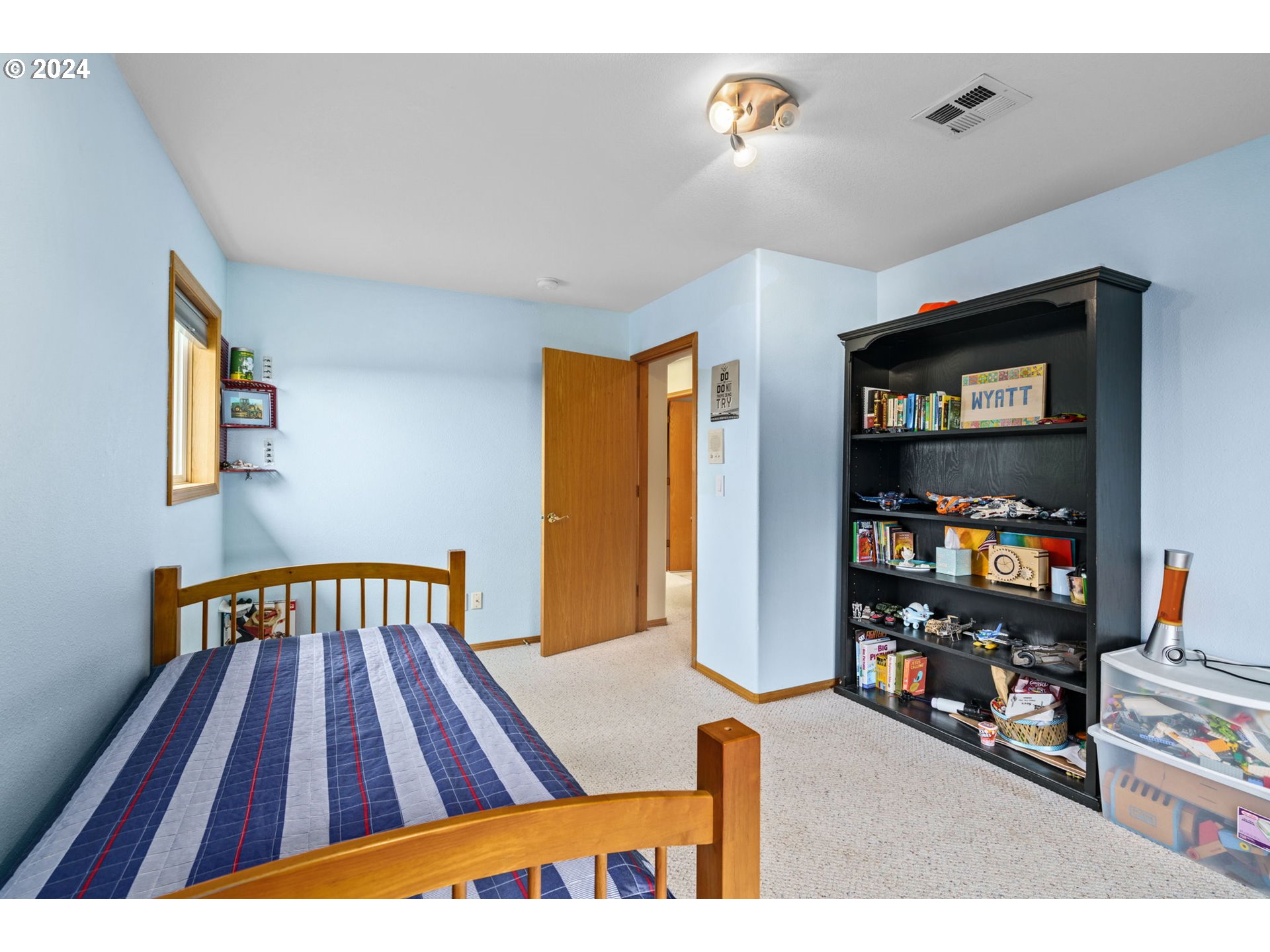 25241 Hall Road Cheshire, OR 97419 - Photo 29 of 48 a bedroom with a bed and a book shelf
