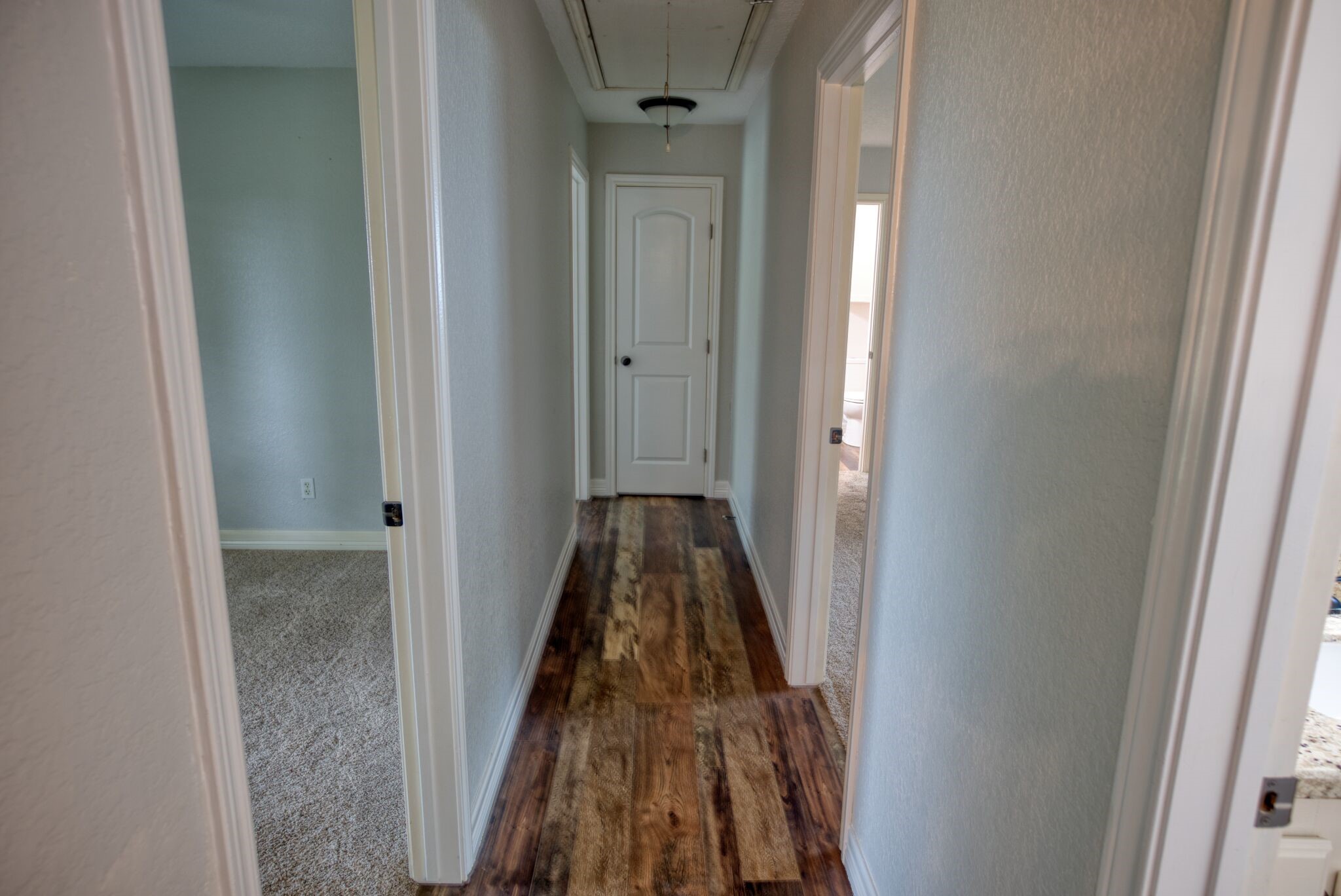 3836 Brazos River Road, Unit CR400 Freeport, TX 77541 - Photo 12 of 43 a view of a hallway with wooden floor and front door