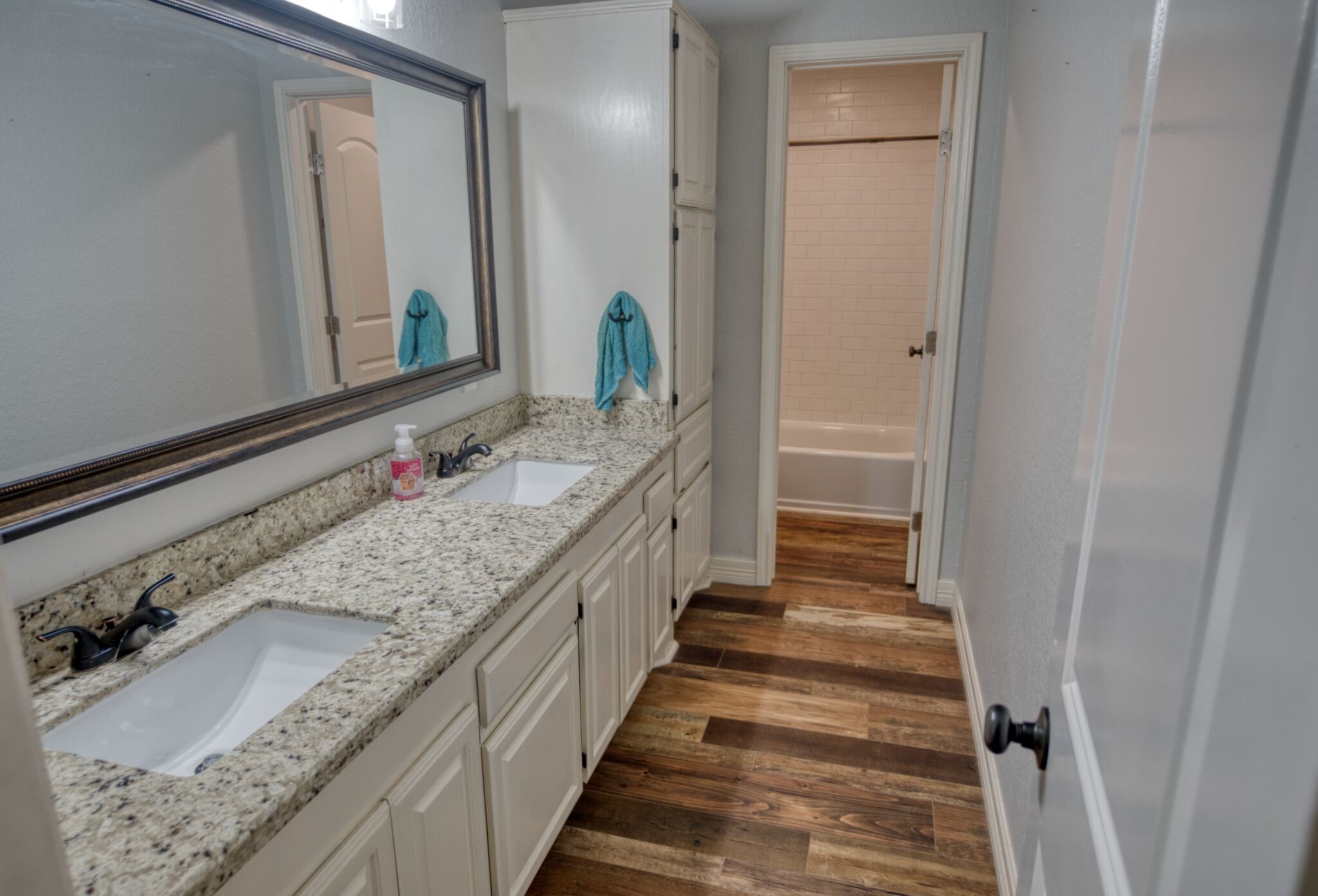 3836 Brazos River Road, Unit CR400 Freeport, TX 77541 - Photo 13 of 43 a bathroom with a granite countertop double vanity sink and a mirror