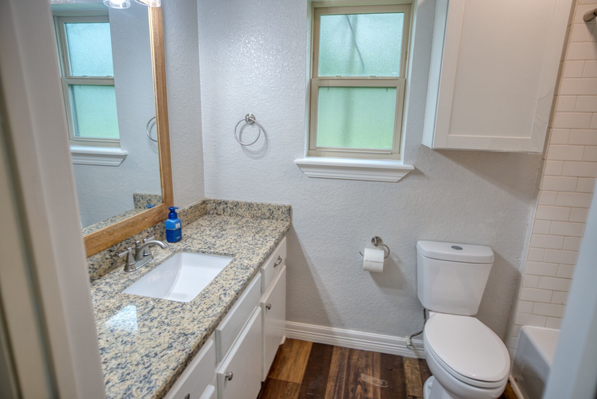 3836 Brazos River Road, Unit CR400 Freeport, TX 77541 - Photo 17 of 43 a bathroom with a granite countertop toilet sink and mirror