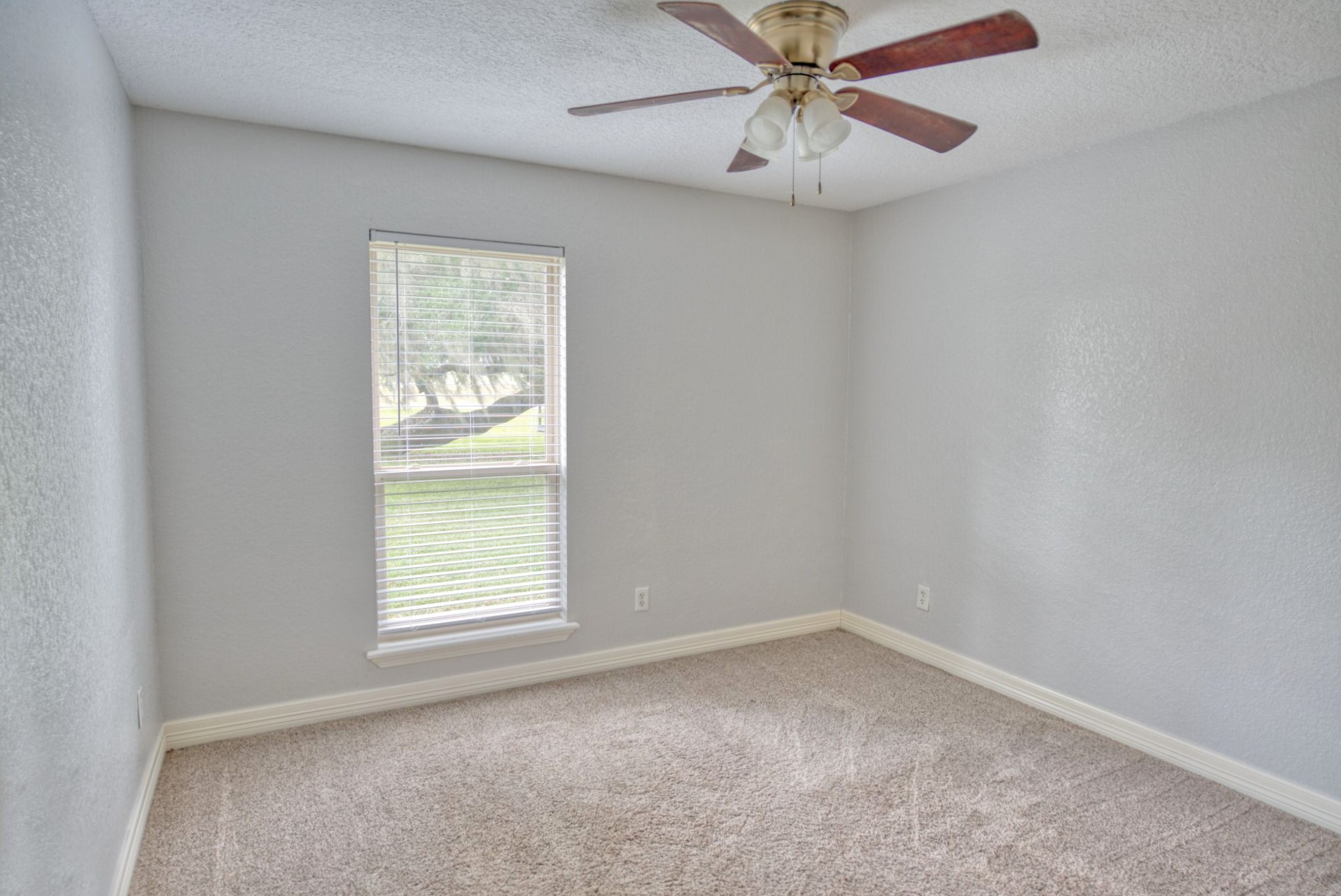 3836 Brazos River Road, Unit CR400 Freeport, TX 77541 - Photo 19 of 43 an empty room with a window and a fan