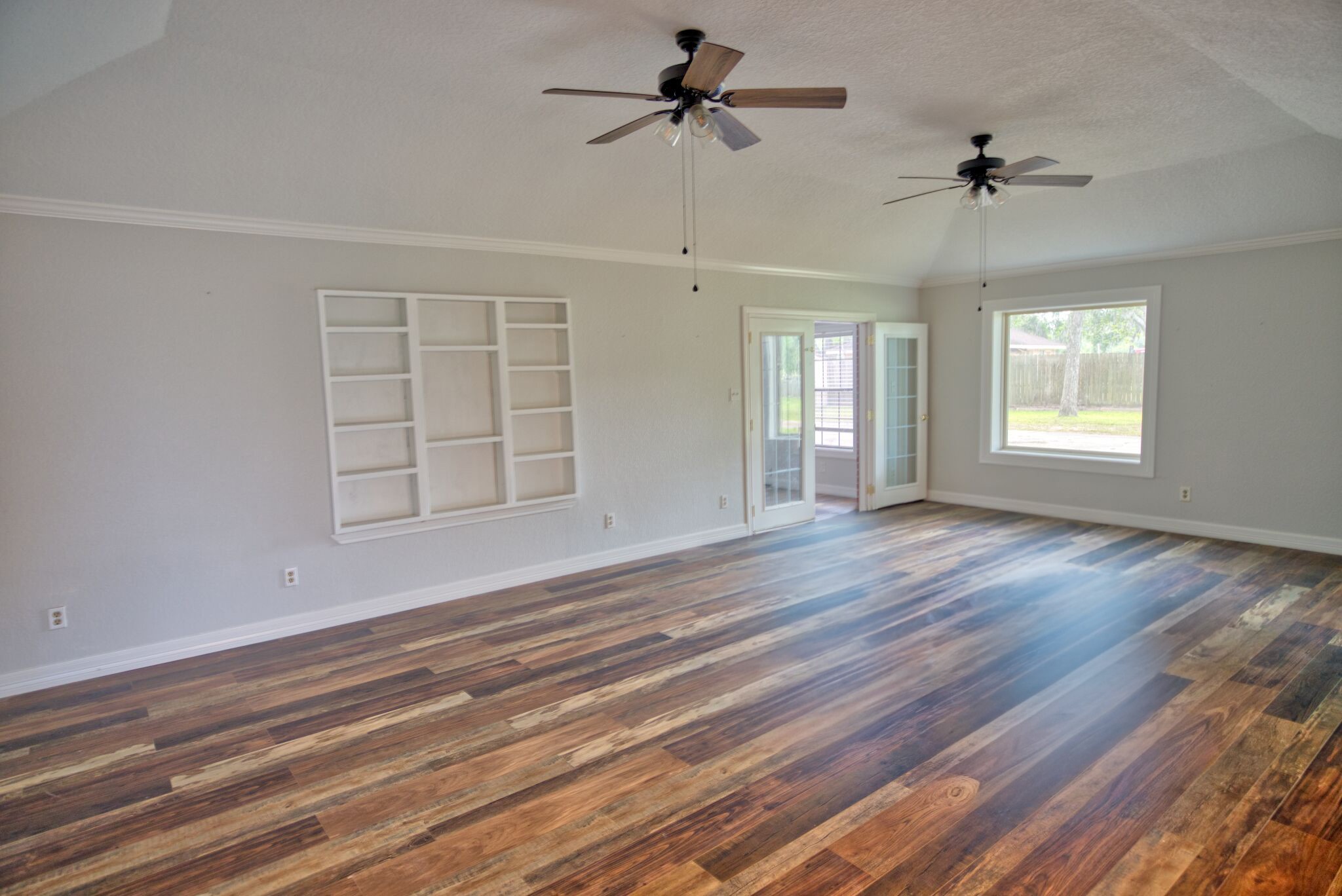 3836 Brazos River Road, Unit CR400 Freeport, TX 77541 - Photo 21 of 43 a view of an empty room with a window and wooden floor