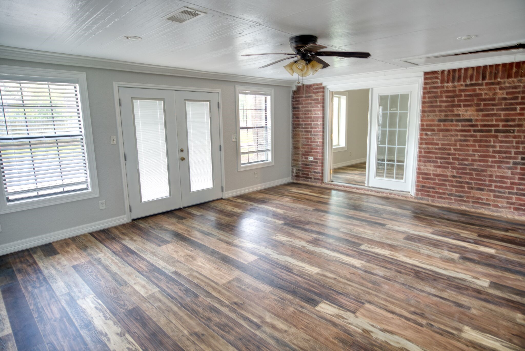 3836 Brazos River Road, Unit CR400 Freeport, TX 77541 - Photo 22 of 43 a view of an empty room with a window and wooden floor