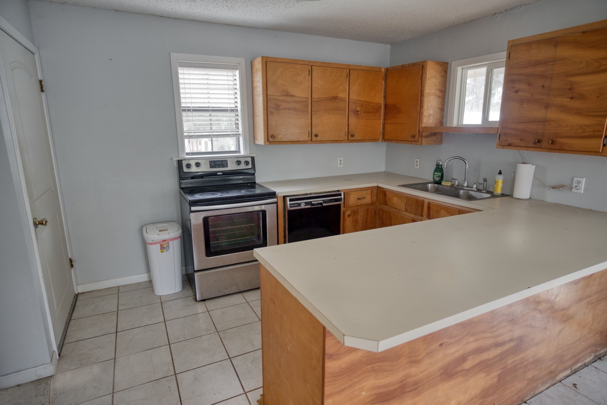 3836 Brazos River Road, Unit CR400 Freeport, TX 77541 - Photo 28 of 43 a kitchen with a sink a stove and cabinets