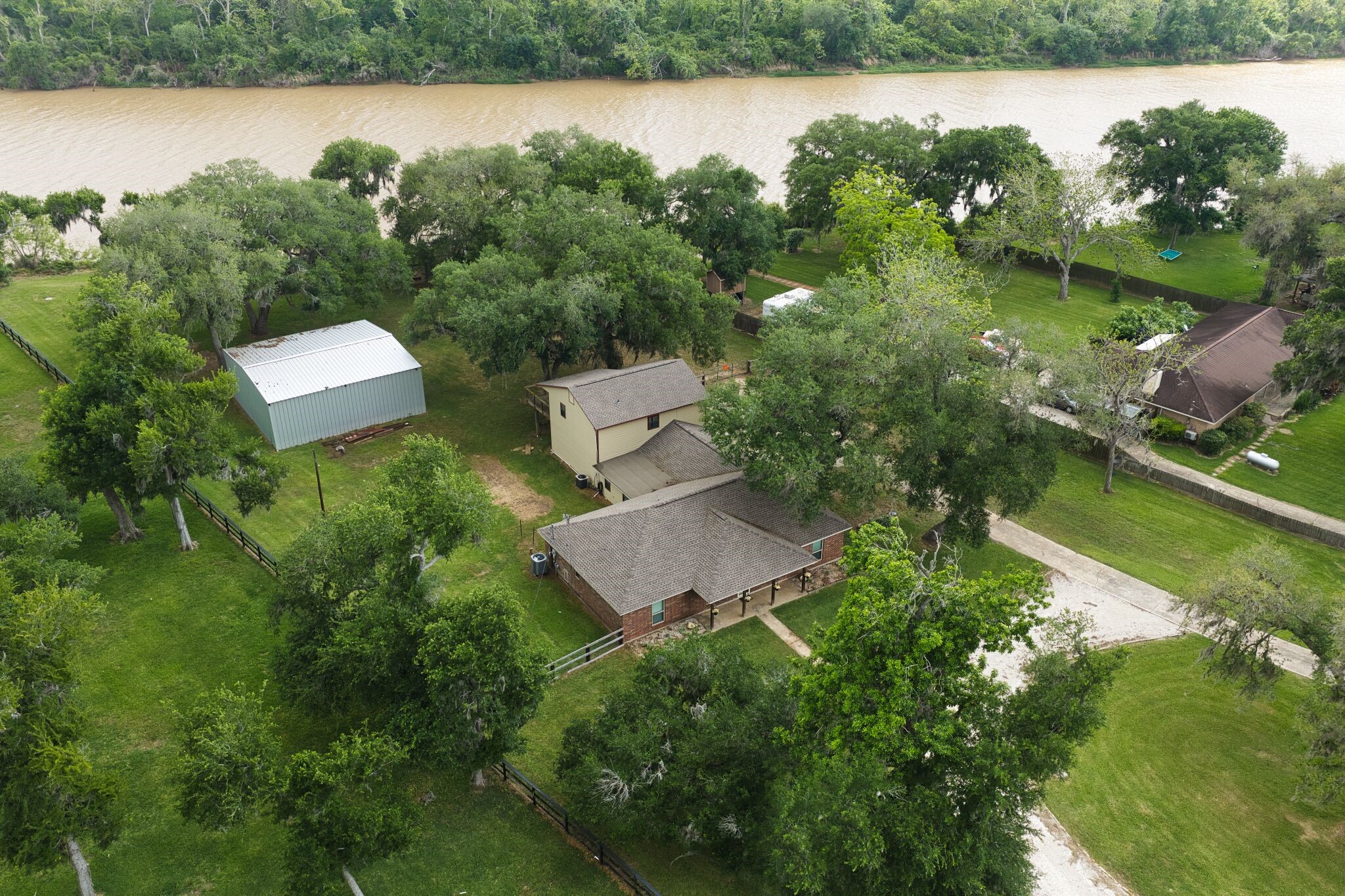 3836 Brazos River Road, Unit CR400 Freeport, TX 77541 - Photo 41 of 43 an aerial view of a house with a garden and lake view