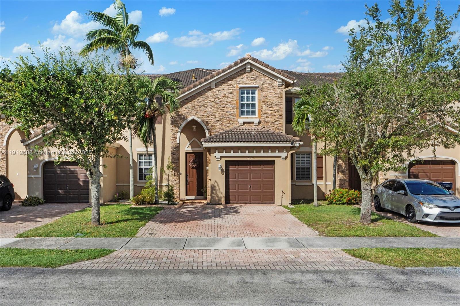 a front view of a house with a yard and garage