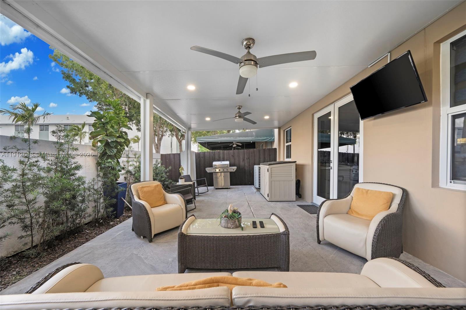 15245 Southwest 8th Way Miami, FL 33194 - Photo 13 of 25 a living room with furniture and a flat screen tv