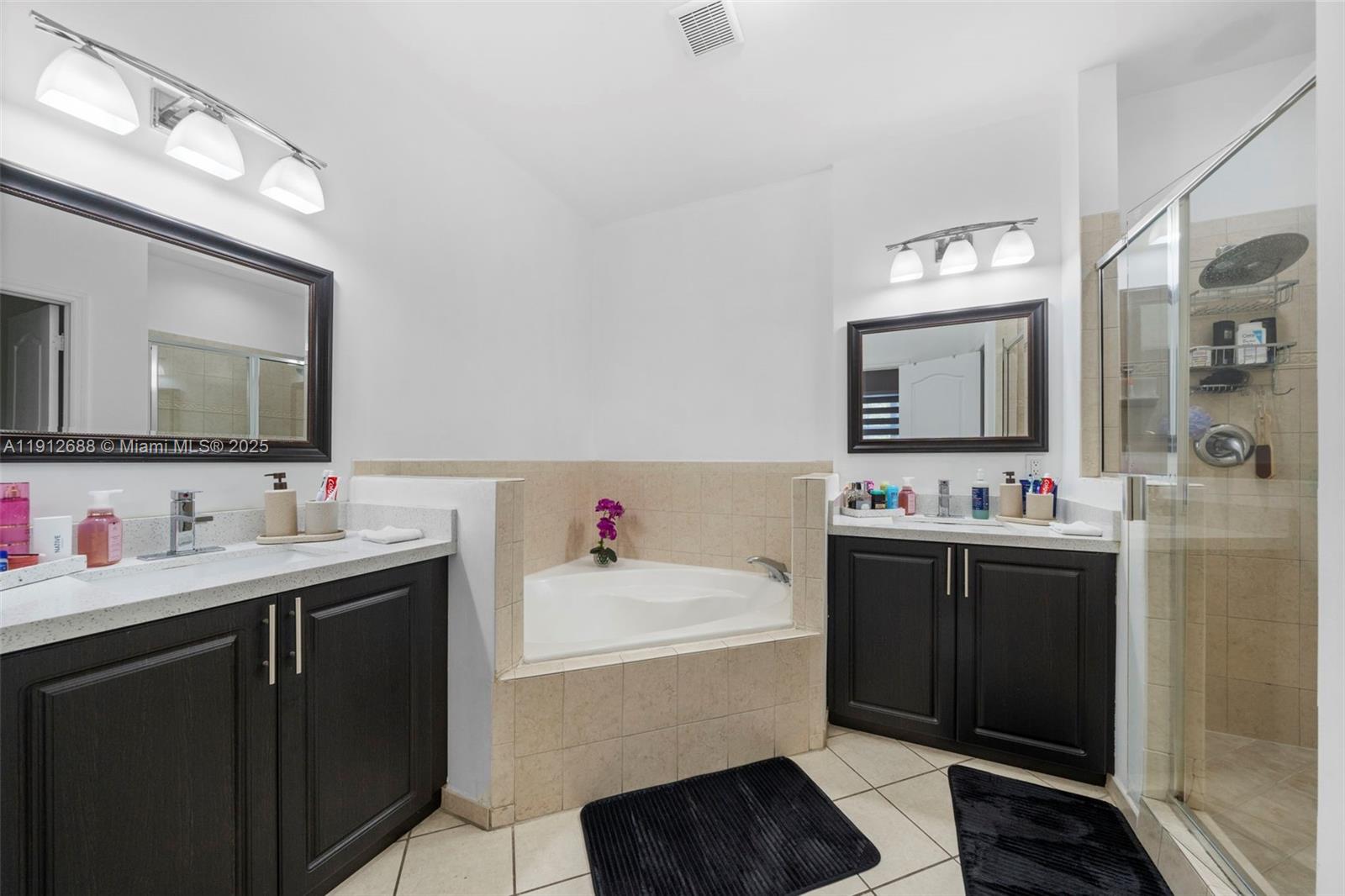 15245 Southwest 8th Way Miami, FL 33194 - Photo 18 of 25 a bathroom with a sink and a mirror