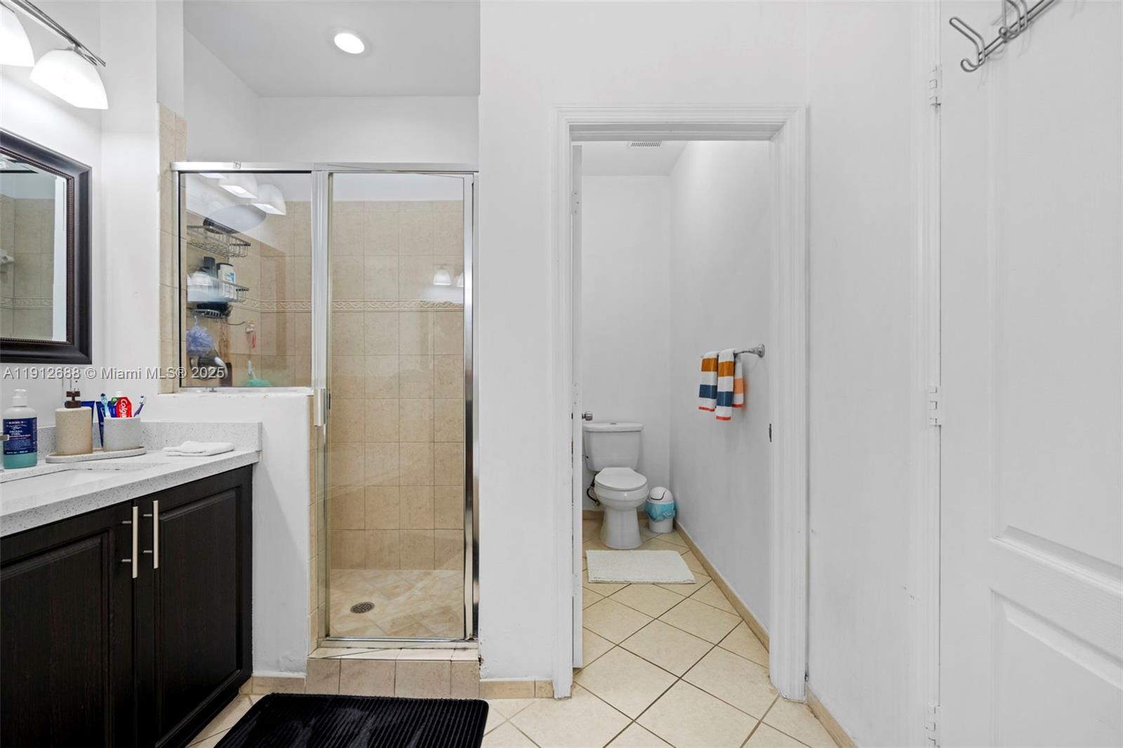 15245 Southwest 8th Way Miami, FL 33194 - Photo 19 of 25 a bathroom with a sink and a mirror