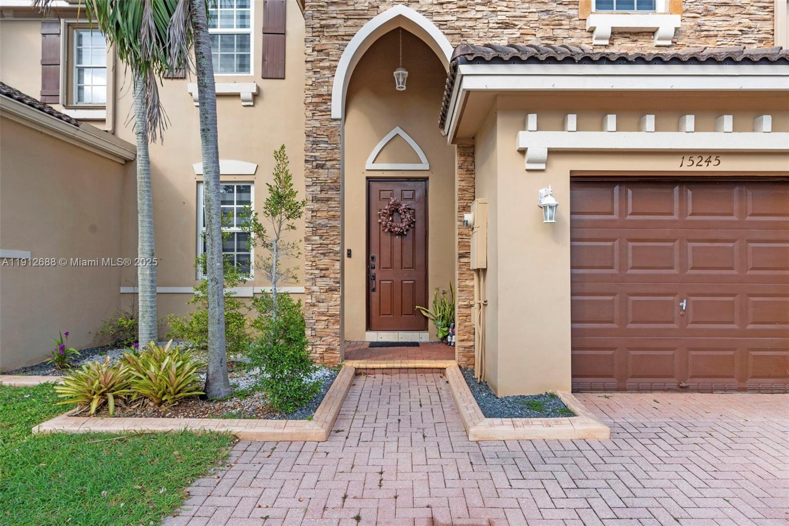 15245 Southwest 8th Way Miami, FL 33194 - Photo 2 of 25 a front view of a house with a garden