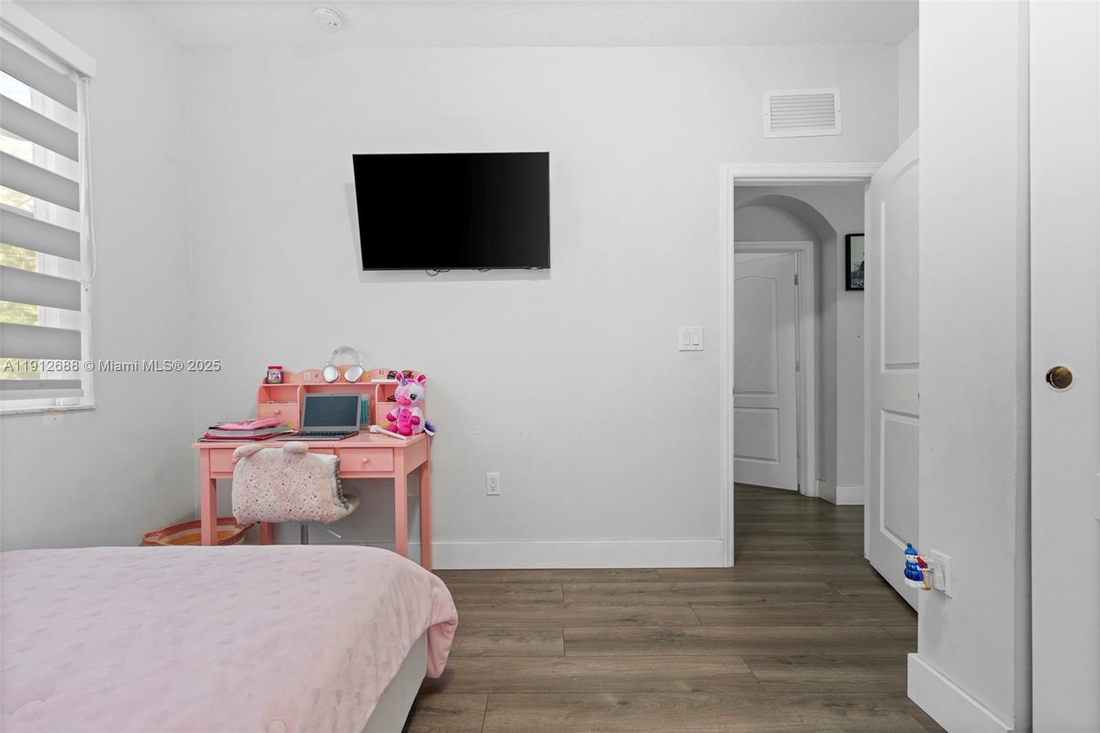 15245 Southwest 8th Way Miami, FL 33194 - Photo 22 of 25 a bedroom with a bed and a flat screen tv