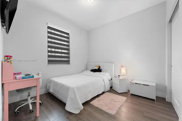 a bedroom with a bed and a television