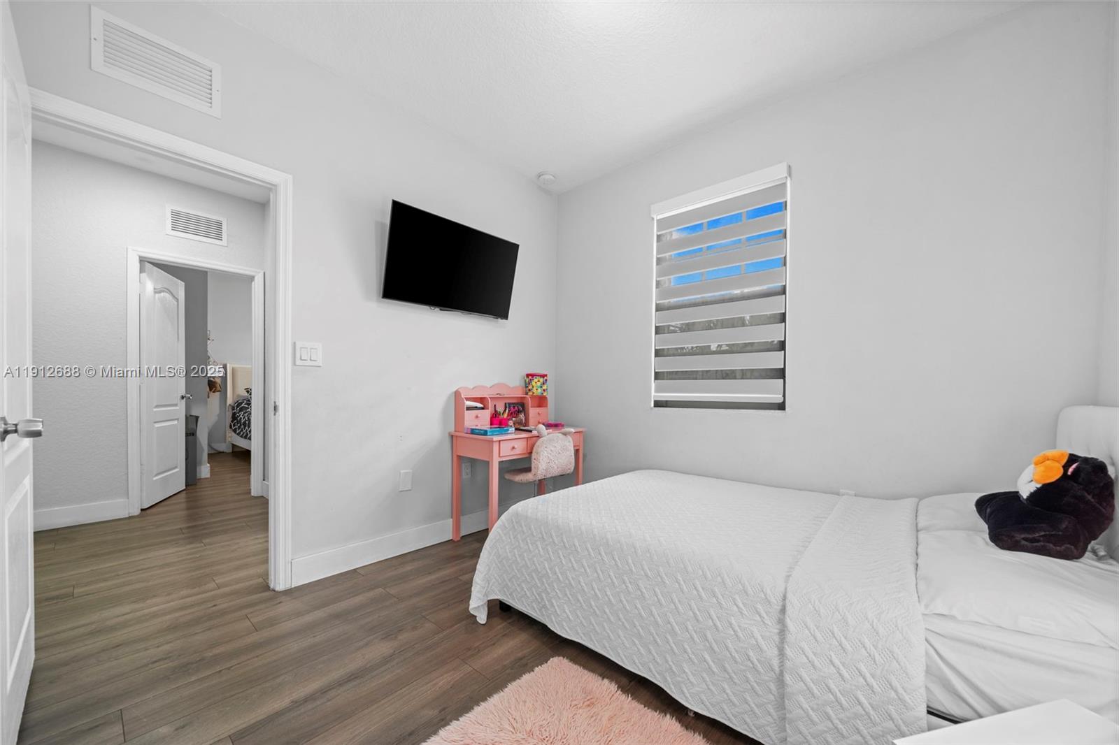 15245 Southwest 8th Way Miami, FL 33194 - Photo 24 of 25 a bedroom with a bed and a television