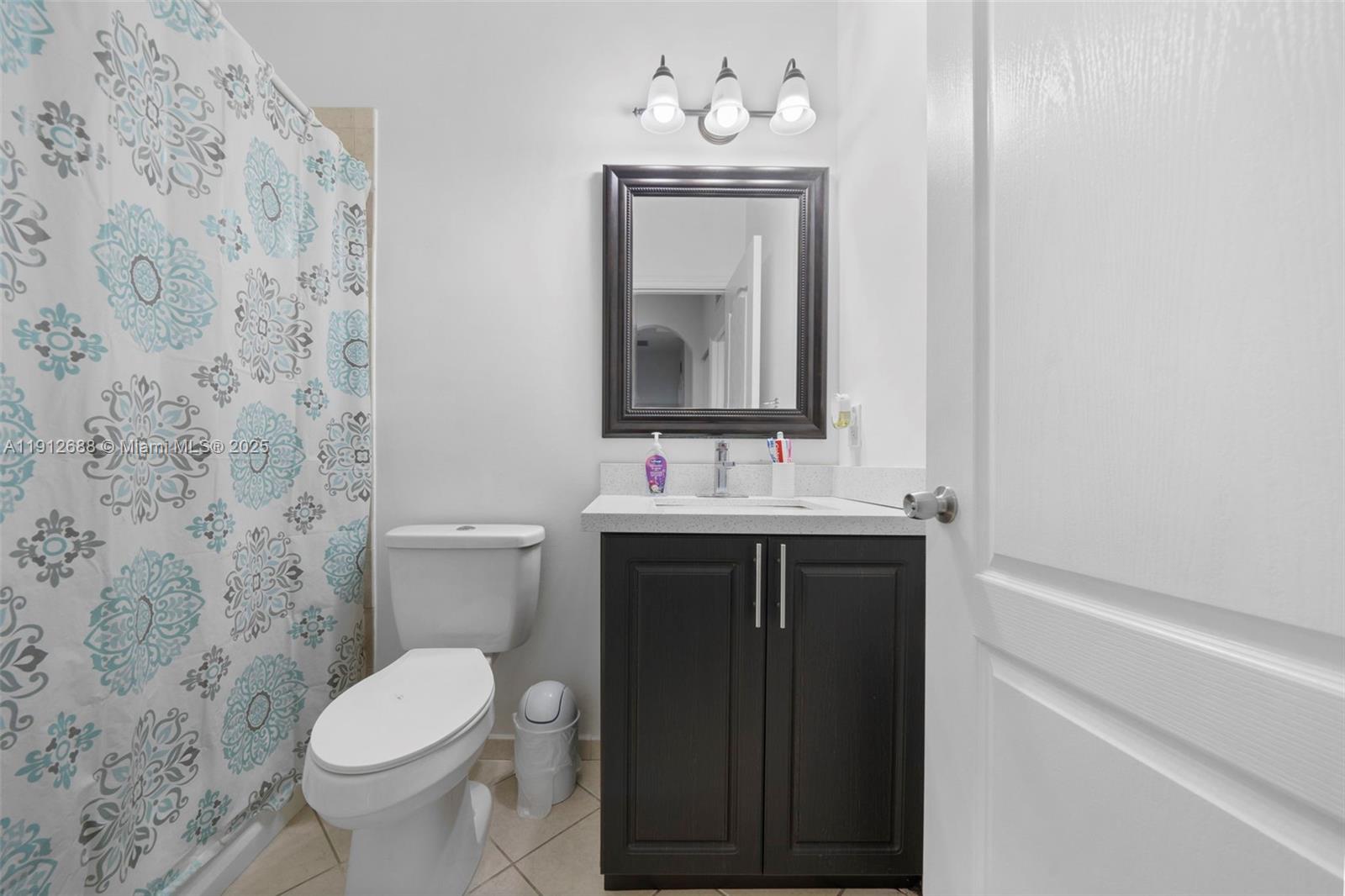 15245 Southwest 8th Way Miami, FL 33194 - Photo 25 of 25 a bathroom with a sink vanity and toilet