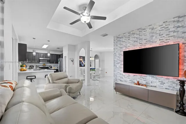 a kitchen with stainless steel appliances granite countertop a refrigerator and a stove top oven