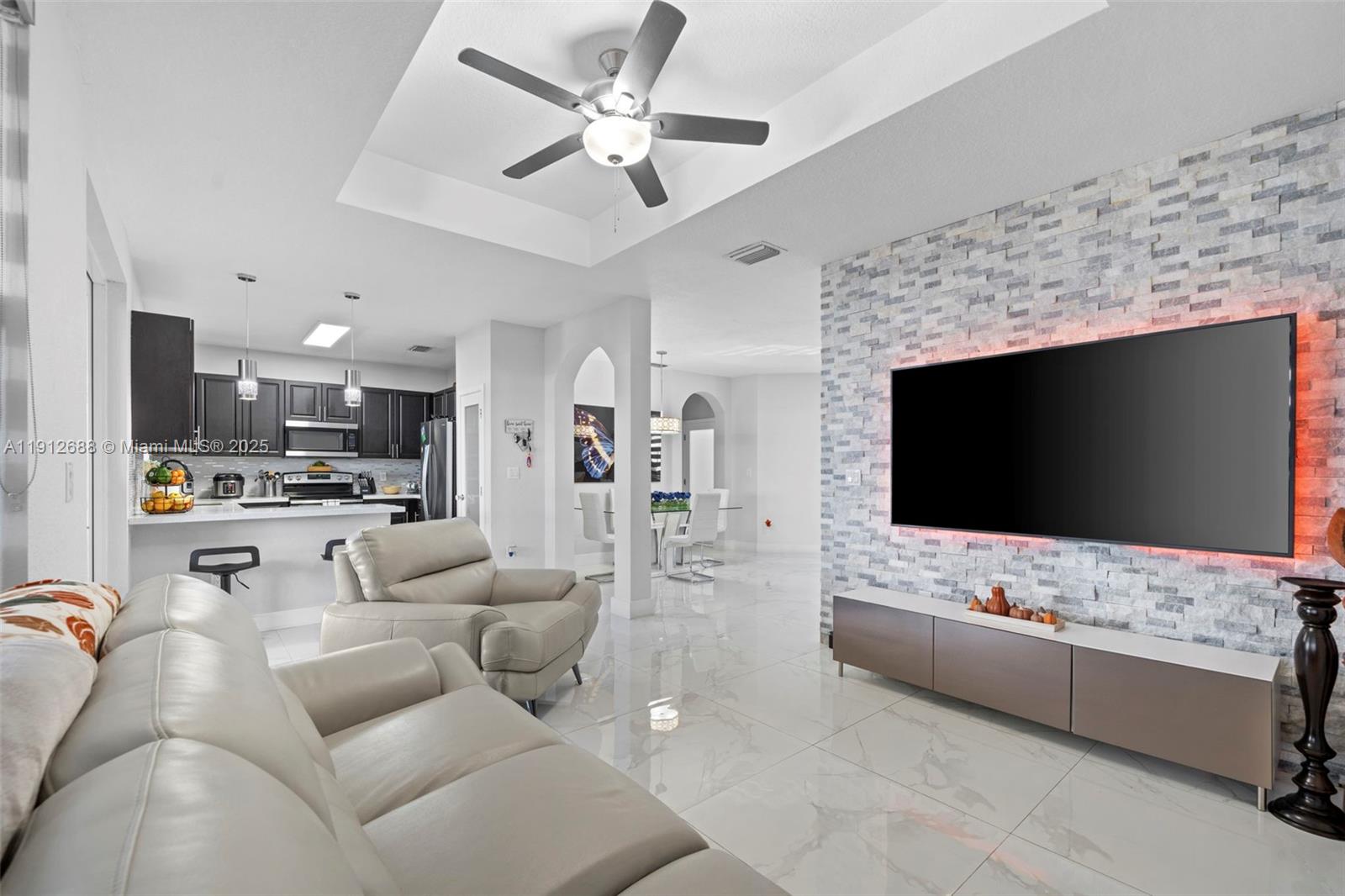 15245 Southwest 8th Way Miami, FL 33194 - Photo 9 of 25 a living room with furniture and a flat screen tv