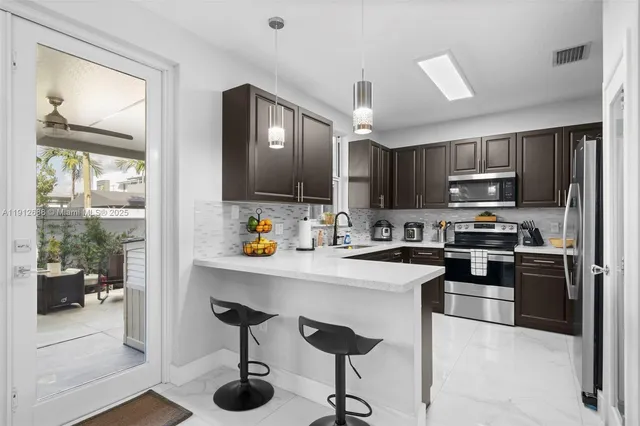 a kitchen with a sink stove and refrigerator