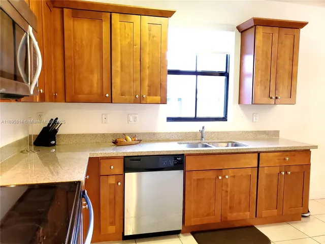 a kitchen with a sink cabinets and a wooden floor