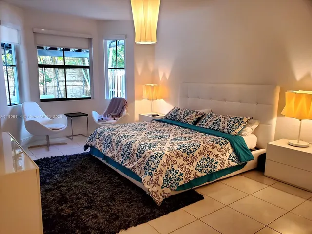 a bedroom with a bed window and couch