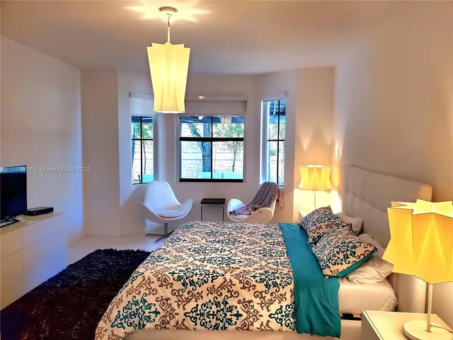 a bedroom with bed and window