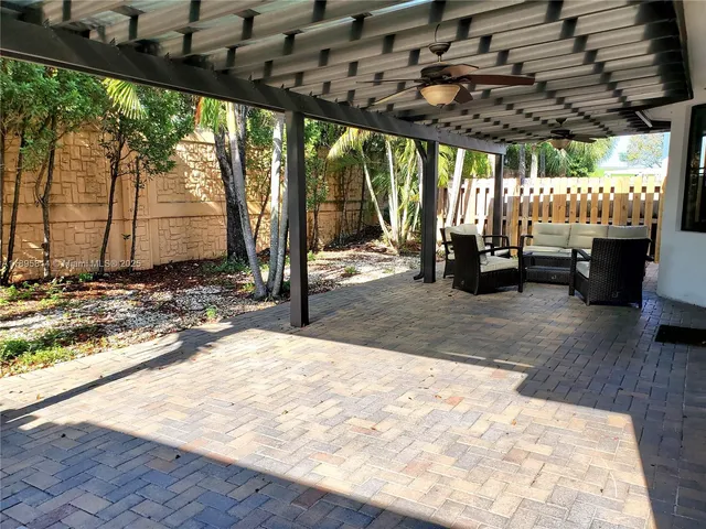 a outdoor sitting area with furniture and a yard