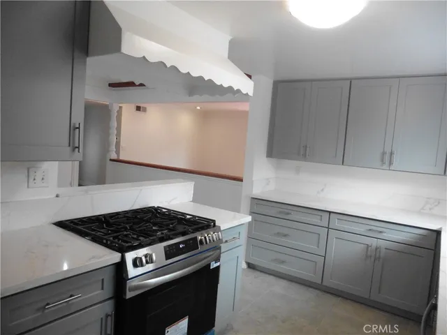 a kitchen with a stove and a window