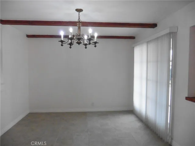 a view of a kitchen with a sink and dishwasher a refrigerator with white walls