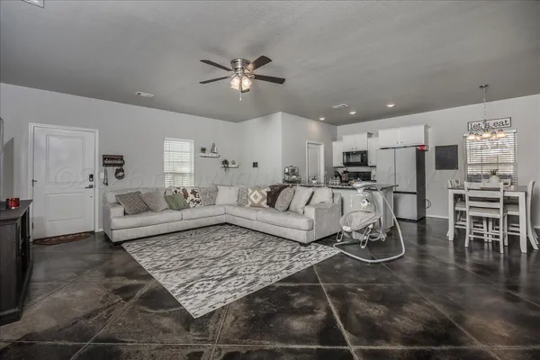 a living room with furniture and kitchen view