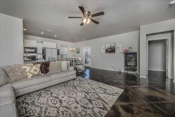 a living room with furniture and wooden floor