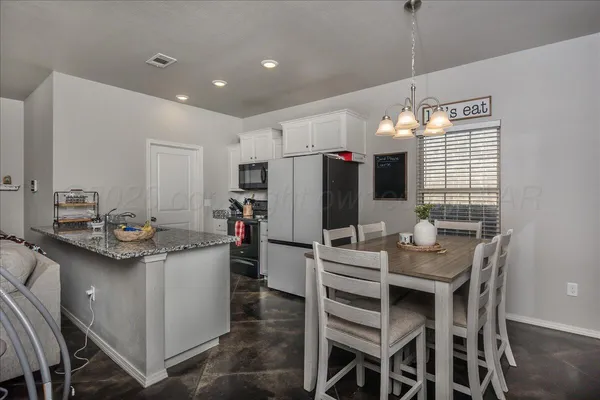 a kitchen that has a table and chairs in it