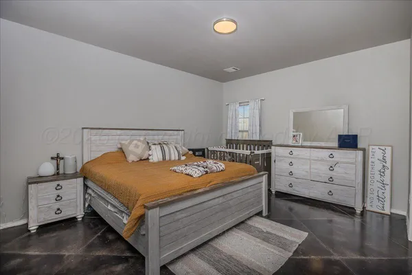 a bedroom with a bed and a dresser