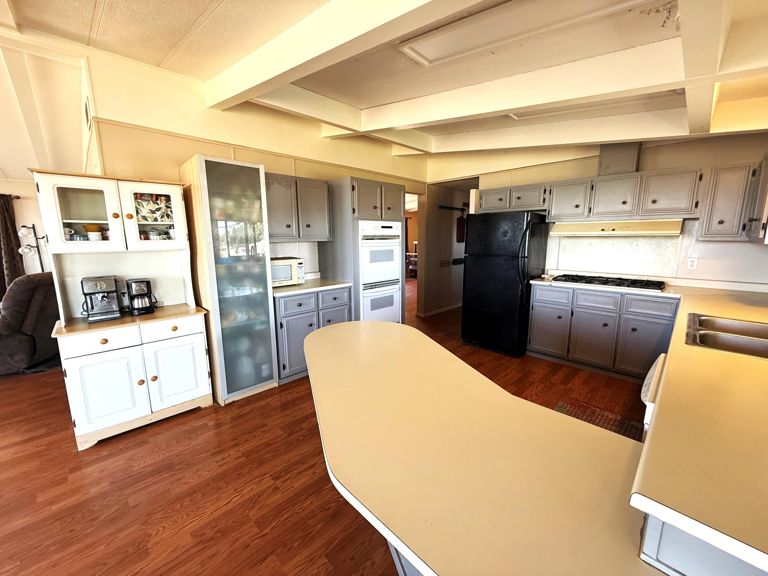 17550 Maupin Road Malin, OR 97632 - Photo 16 of 62 a kitchen with stainless steel appliances a refrigerator and wooden floor