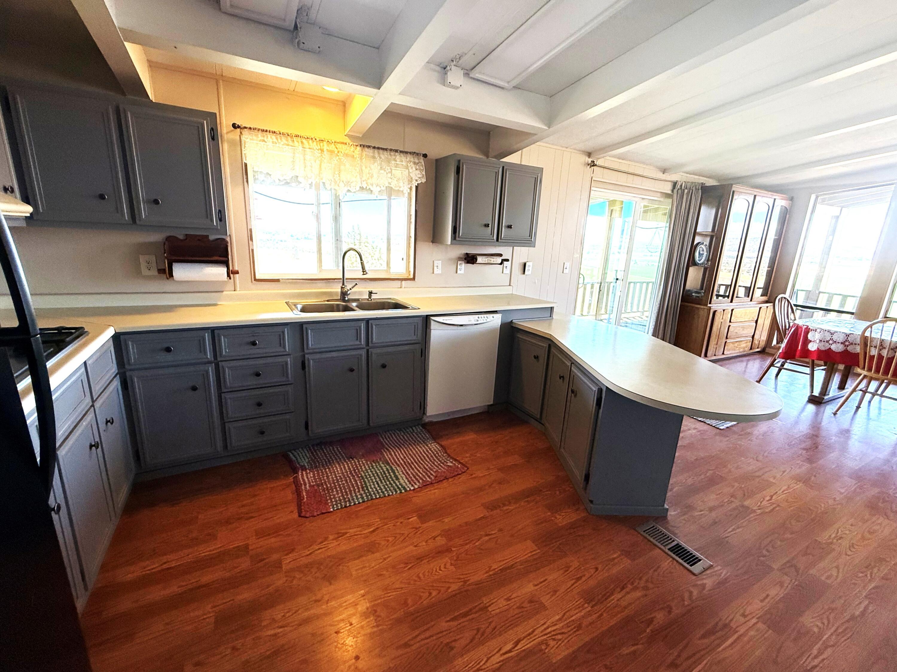 17550 Maupin Road Malin, OR 97632 - Photo 17 of 62 a large kitchen with wooden floors and a sink
