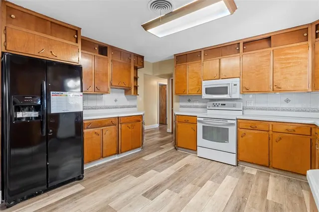 a kitchen with stainless steel appliances granite countertop a stove sink and cabinets