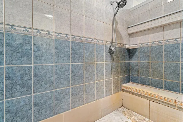 a bathroom with a bathtub and shower