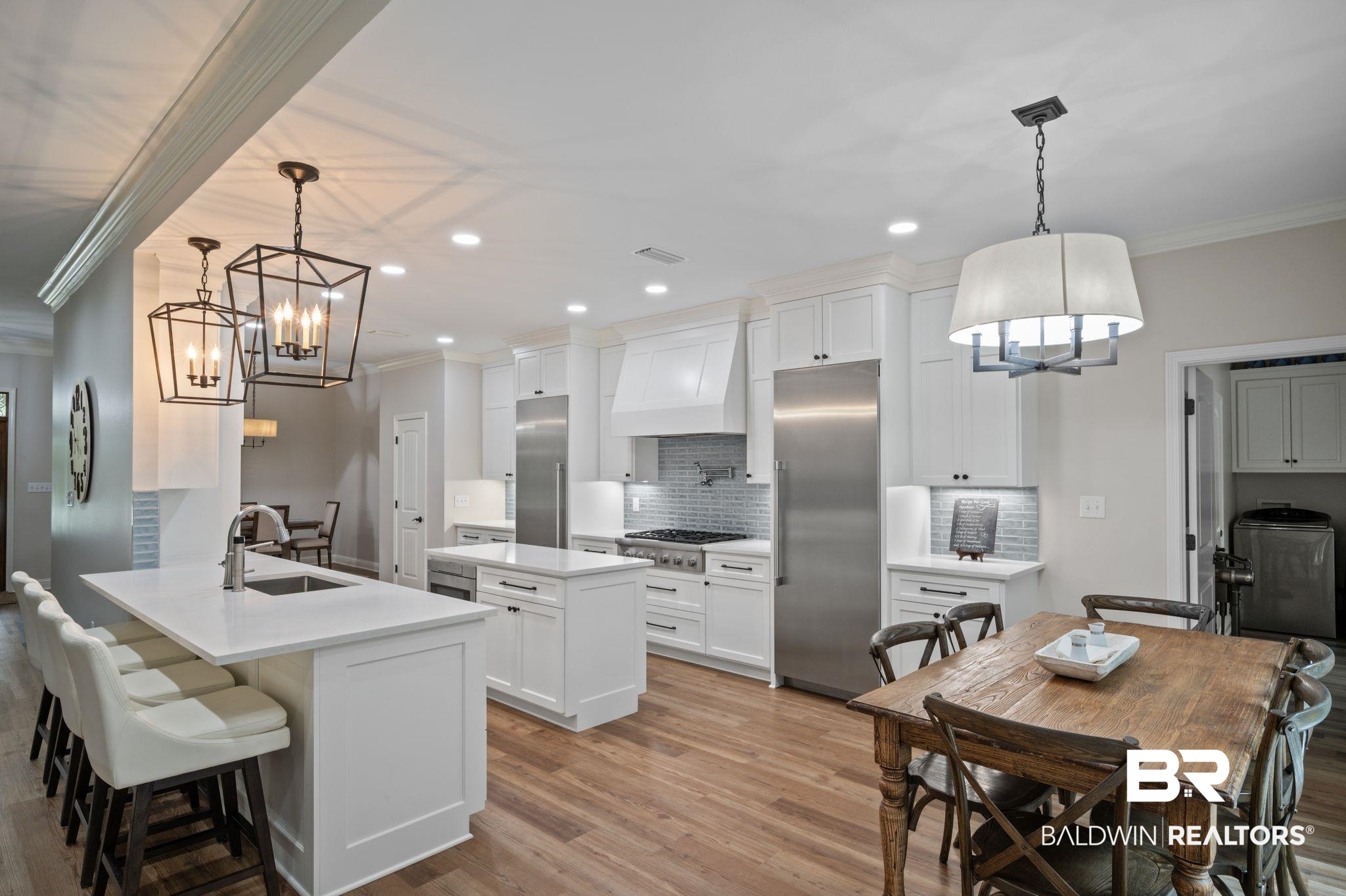 14591 Styx River Road Stapleton, AL 36578 - Photo 11 of 47 Kitchen featuring appliances with stainless steel finishes, a chandelier, ornamental molding, a sink, and tasteful backsplash